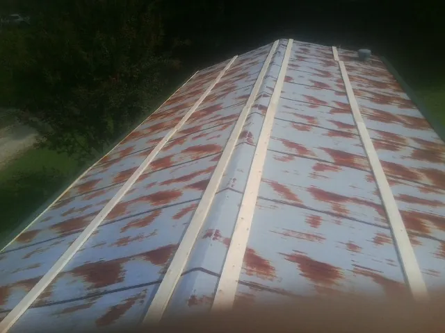 Rusted metal roof panels with new wood purlins before replacement — Storm Damage Roof Repair in Paint Bank by Roofing Brothers